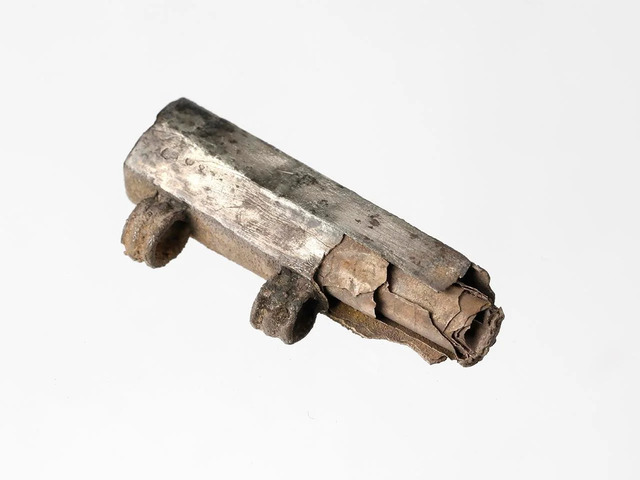 A rolled silver amulet, dating back to approximately 230–260 CE, showcasing ancient craftsmanship.