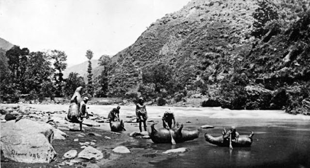 A serene moment captured as villagers launch their inflated bullock skin boats into the water.