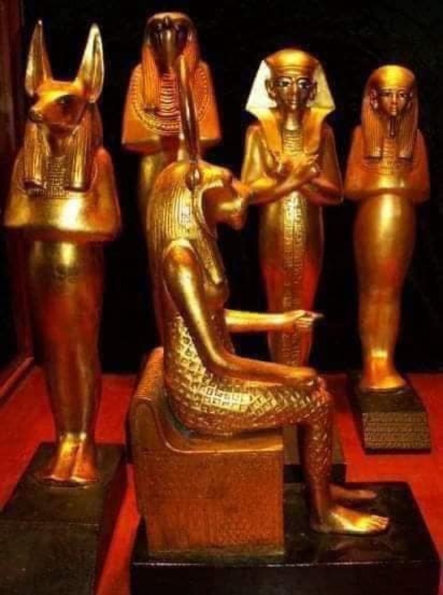 A set of gold statuettes depicting Egyptian deities, found in King Tutankhamun's tomb, highlighting the spiritual significance of these artifacts.