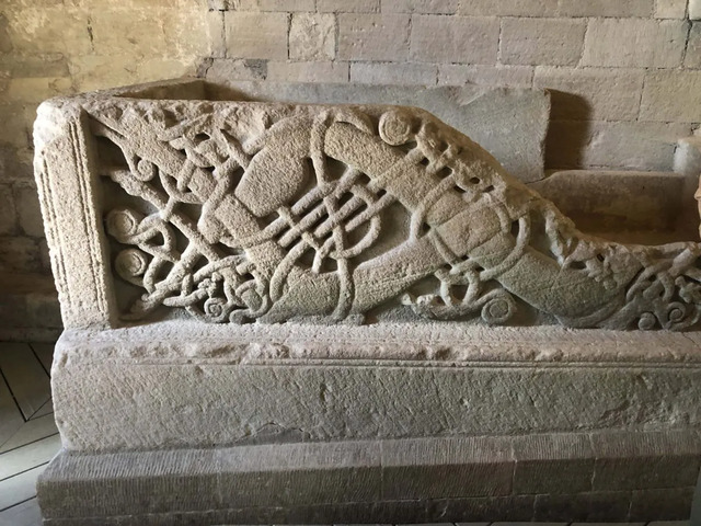 An intricately engraved stone artifact inside The Rock of Cashel, representing the rich cultural and spiritual heritage of ancient Ireland.