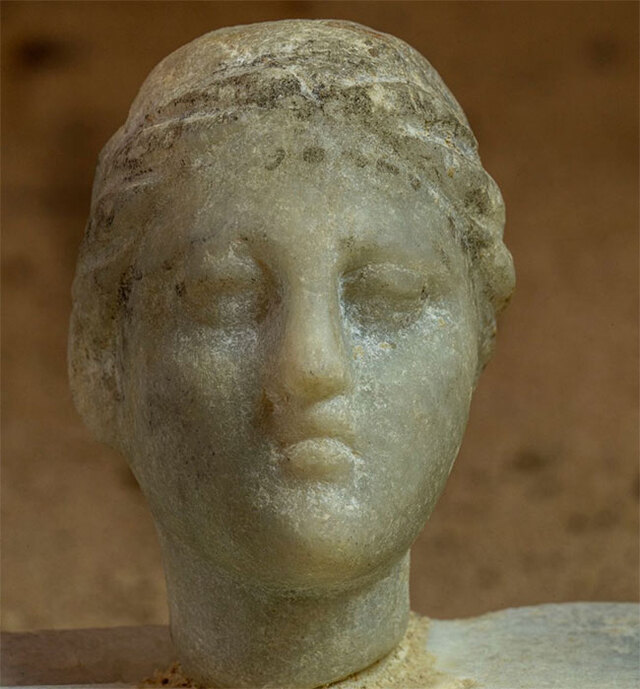 A striking limestone bust of a king adorned with the Nemes headdress hints at connections to the late Ptolemaic Period.