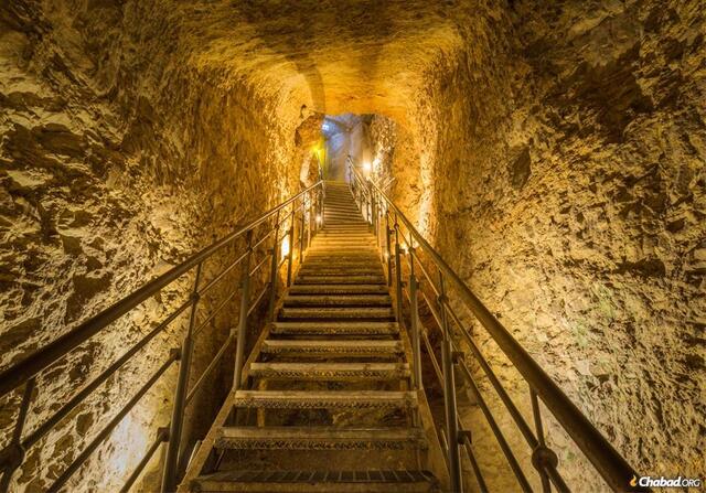 A view inside Hezekiah's Tunnel with metal stairs, allowing modern visitors to explore this ancient engineering marvel.