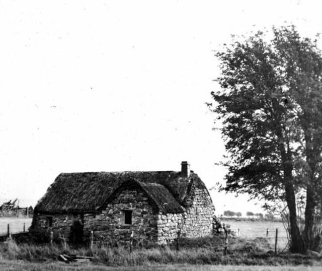 A vintage photograph of Old Leanach Cottage, capturing its enduring architectural beauty.