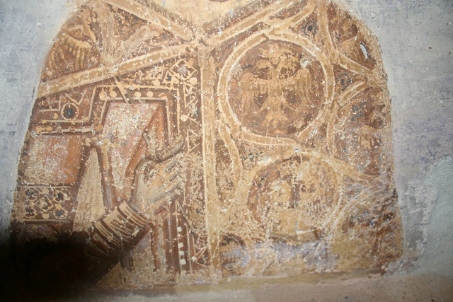 A zoomed-in view of the regalia on the emperor’s chest, featuring the double-headed eagle emblem, a symbol of the Palaiologos dynasty’s authority and legacy.