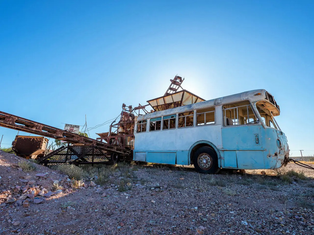 Abandoned mining equipment and vehicles lie scattered across Coober Pedy, silent witnesses to its opal rush days.