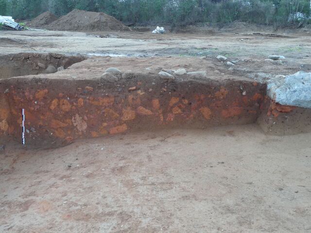 Adjacent to the kiln was a robust structure with thick walls supported by buttresses, hinting at its significance.