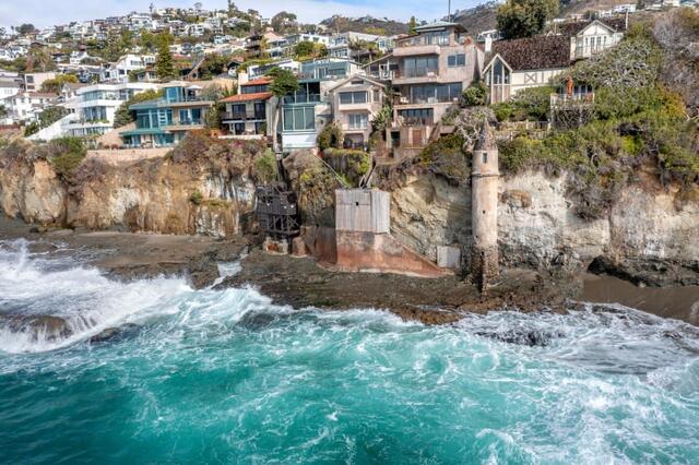 An aerial view showcasing La Tour amidst the rugged coastline and residential beauty of Laguna Beach.