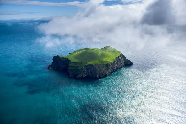 An enchanting aerial view of the island, emphasizing the striking solitude of its single dwelling.