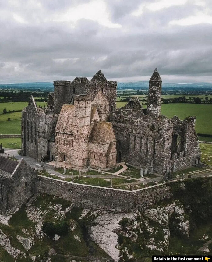 A striking aerial view of The Rock of Cashel, standing tall against the lush Irish countryside, a beacon of history and architecture