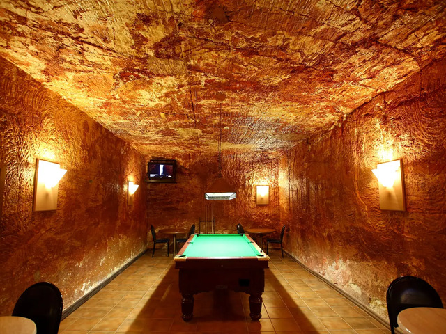 An underground game room in Coober Pedy provides entertainment in the cool safety below ground.