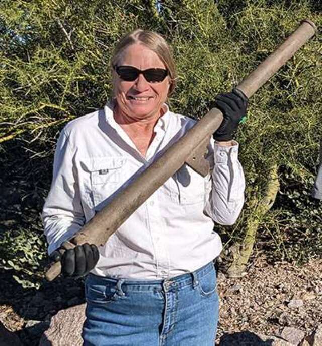 Archaeologist Deni Seymour proudly holds the cannon she uncovered in southern Arizona, a piece of history long buried.