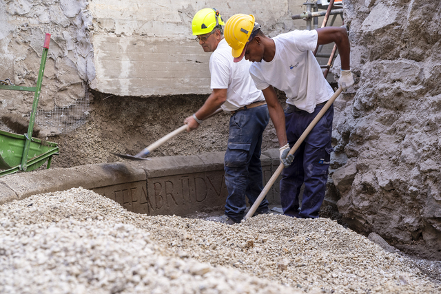 Archaeologists clearing gravel from the base of the tomb to further study its inscriptions and architectural features. (Credit: Archaeological Park of Pompeii)