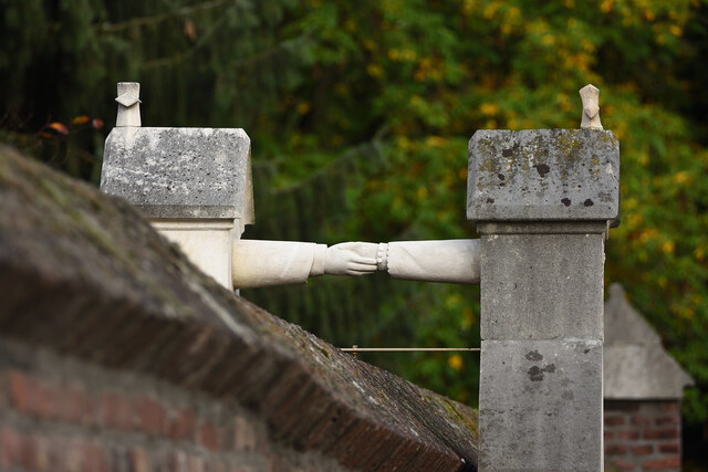 At the top of each tombstone, a cross signifies their shared Christian faith, despite their differing denominations.