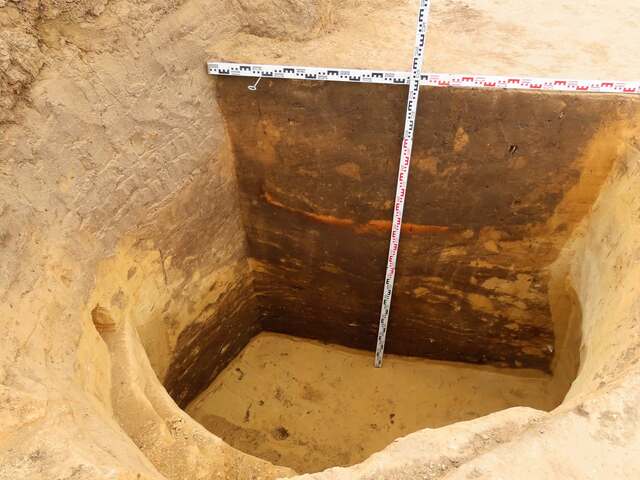 Close-up of a deep clay pit used for wall-building material in the Neolithic settlement.