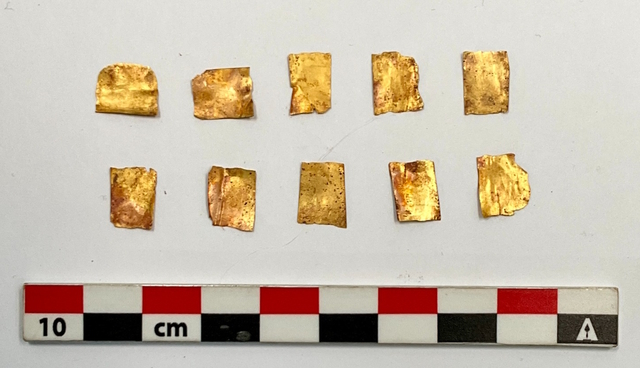 Close-up of gold fragments, showcasing the intricate craftsmanship used during the Ptolemaic era to create symbolic objects for rituals and burials.