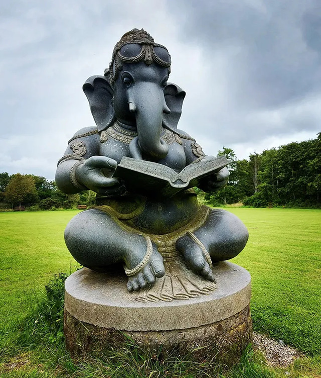 Ganesha with a Book: This serene sculpture represents wisdom and knowledge, highlighting Ganesha's role as the remover of obstacles at Victor’s Way.