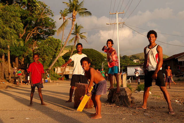 Laughter and Cricket: Children of Hanuabada Bring Streets to Life in Port Moresby, Papua New Guinea (Captured February 24, 2012)