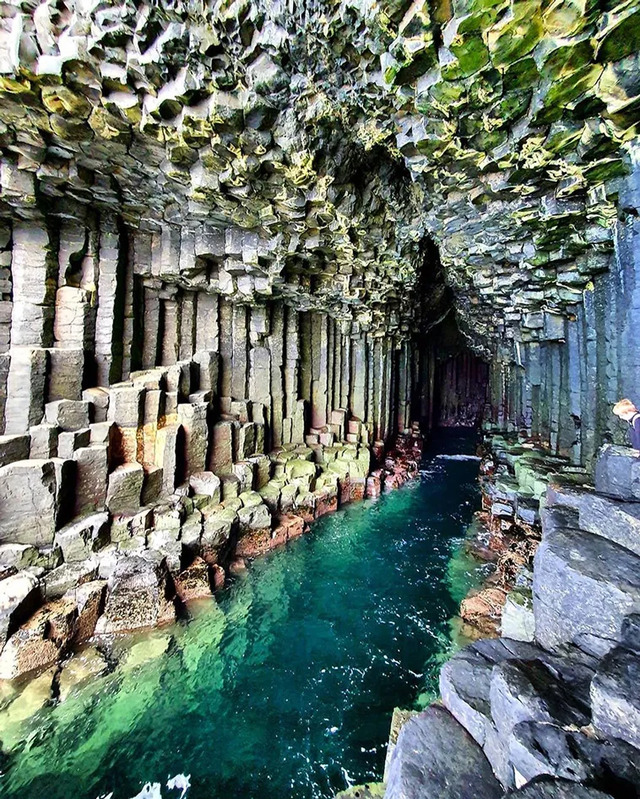 Lava flows slowly cooled and fractured into hexagonal columns, creating a strikingly geometric pattern