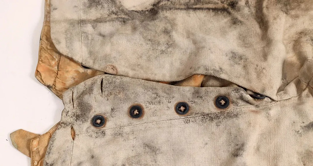 Made of sturdy, white fabric with a five-button fly, these pants were likely designed for heavy labor, reflecting the practical needs of miners during the Gold Rush