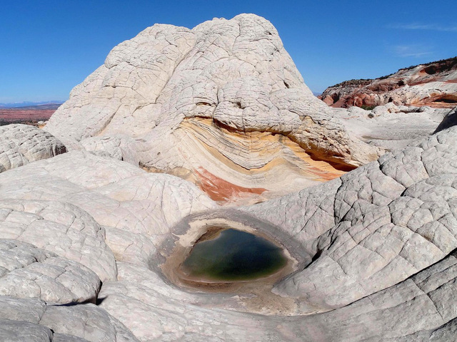 Nestled within the Vermilion Cliffs National Monument in northern Arizona, White Pocket stands as a mesmerizing testament to nature’s artistry