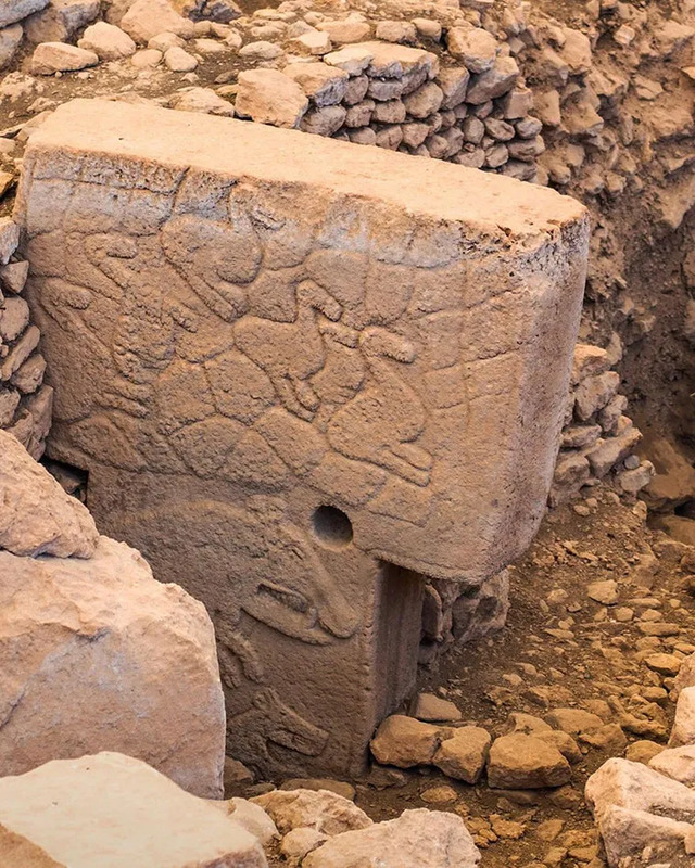 One of the richly decorated T-shaped pillars from Göbeklitepe, engraved with depictions of wild animals and symbolic patterns. 