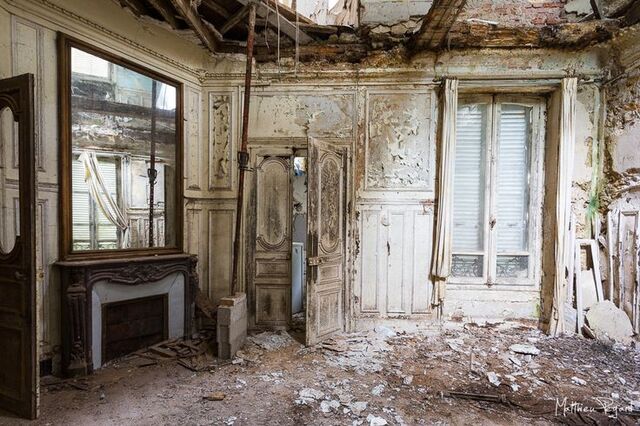 Peeling paint and ornate molding in an empty chamber hint at the rich history of this French chateau.