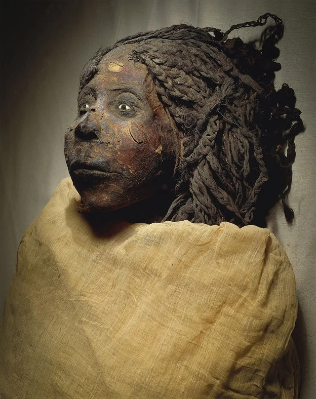 Queen Nodjmet's mummified remains, wrapped in her burial cloth, preserving her legacy for future generations to marvel.