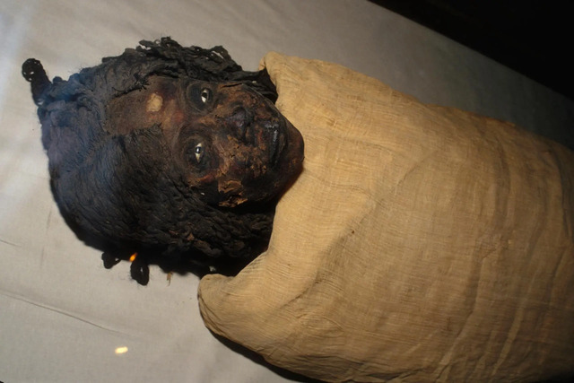 Queen Nodjmet's mummy wrapped in linen, offering a solemn reminder of the Egyptian traditions of afterlife preparation.