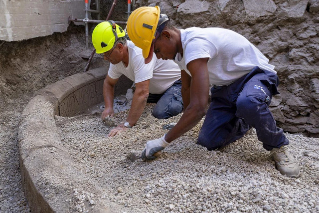 Researchers carefully removing sediment from around the tomb's perimeter to ensure the preservation of its structure. (Credit: Archaeological Park of Pompeii)