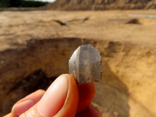 Sharp-edged obsidian fragment, indicative of long-distance trade connections during the Neolithic.