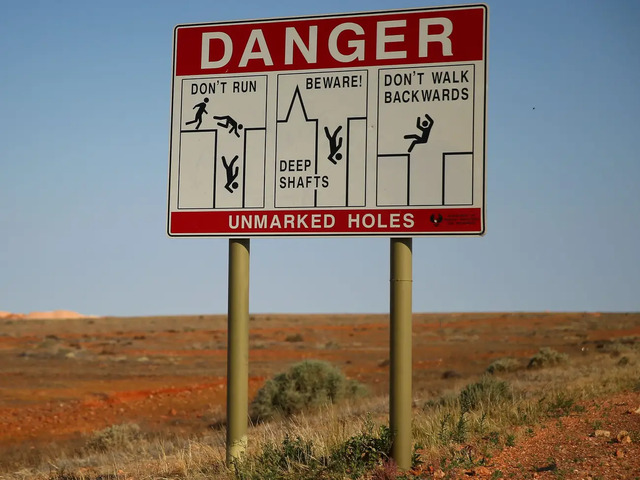 Signs throughout the town warn visitors about the dangers of the deep, open mine shafts.