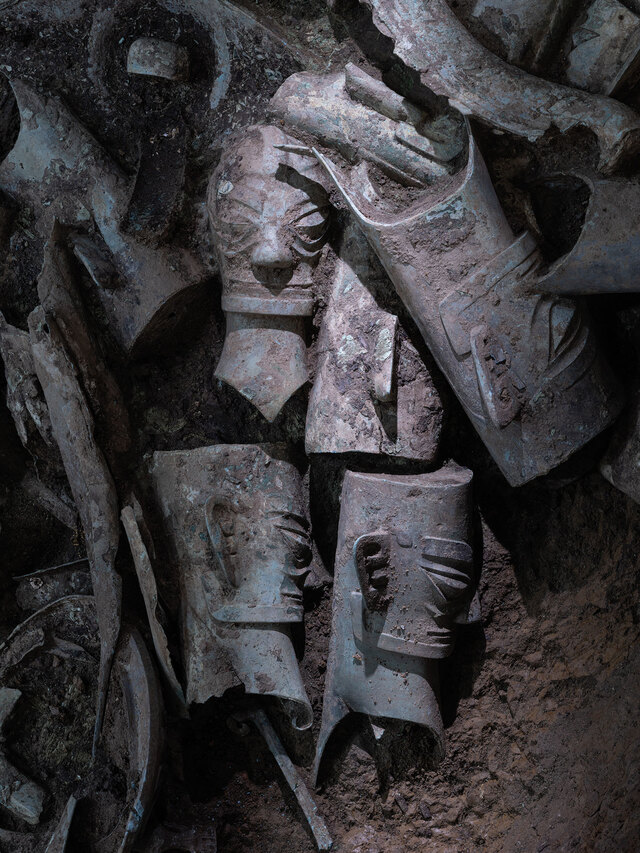 Some of the bronze heads feature intricately pinned hairstyles, while others have flat tops and braided hair at the back, showcasing a variety of cultural practices.