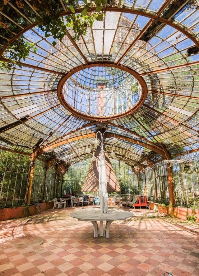 The Abandoned Greenhouse of La Serre du Chirurgien Still Contains Furniture, Preserving Echoes of Its Past.