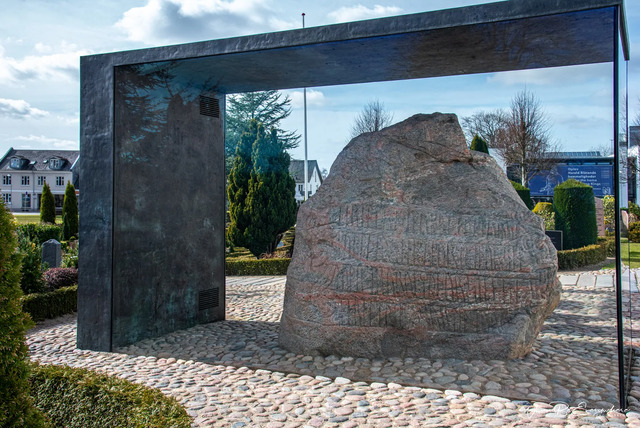 The Jelling Stone displayed under a protective structure in the town of Jelling, preserving this UNESCO World Heritage Site for future generations.