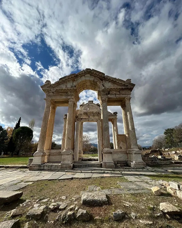 The Tetrapylon of Sagalassos, a monumental gateway standing proudly under dramatic skies.