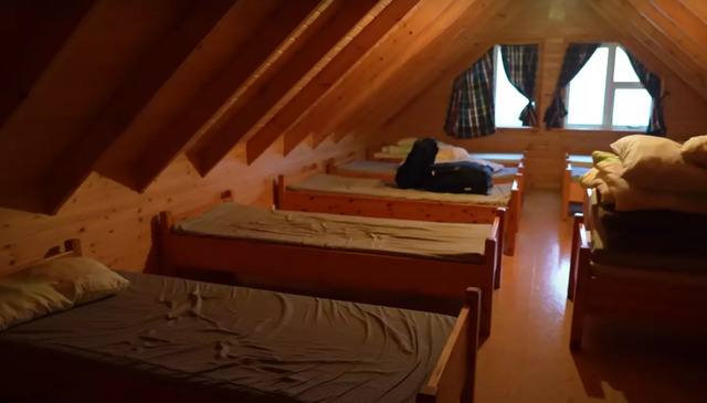 The attic-style sleeping area inside the house, offering a glimpse of its modest living conditions.