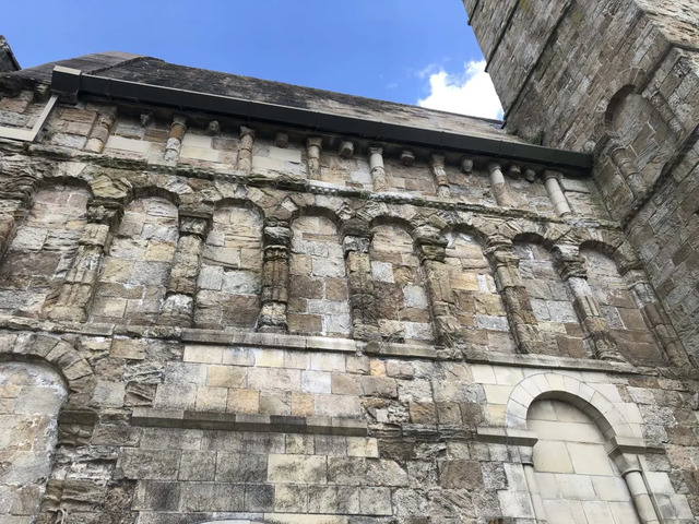 The beautifully preserved outer walls of Cormac's Chapel, featuring unique Romanesque arches and designs.