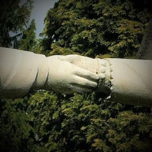 The clasped hands—a powerful symbol of unbroken connection.