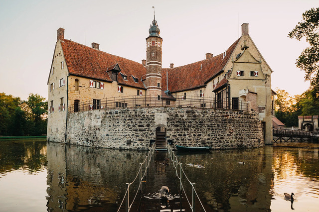 The front view of the castle with its traditional wooden drawbridge, inviting visitors into its historical charm.