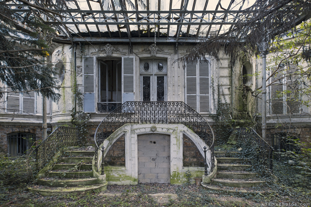 The grand symmetrical staircases leading to the chateau's entrance, now a haunting reminder of its former glory.