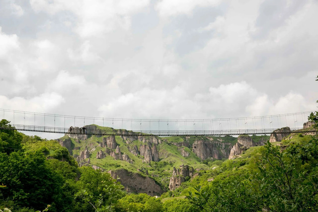 The iconic Swinging Bridge, a symbol of adventure and connection, swaying gracefully over its timeless path