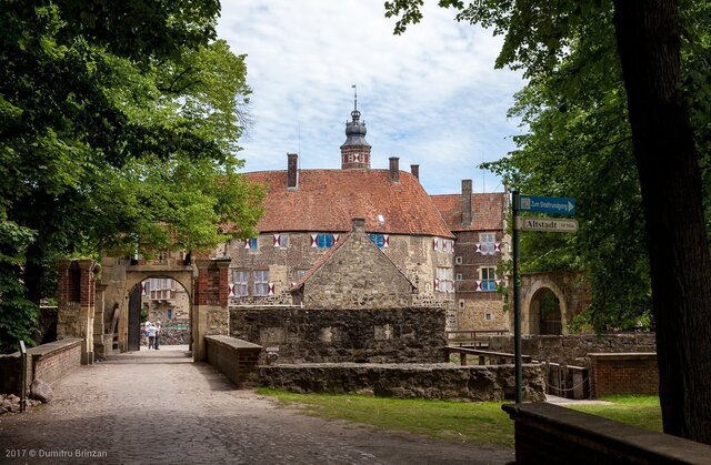 The majestic entrance of Vischering Castle as seen from the main pathway, revealing its fort-like structure.