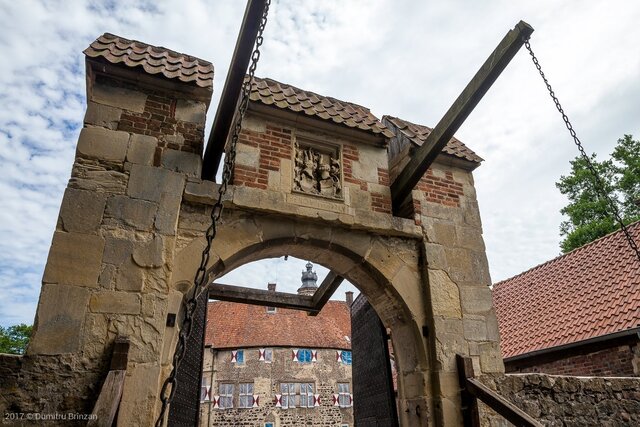 The sturdy wooden drawbridge leading to the main gate, offering a glimpse into its medieval defense mechanisms.