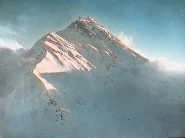 The summit of Mount Everest in a 1924 hand-tinted photograph, symbolizing the enduring mystery of Mallory and Irvine’s attempt.