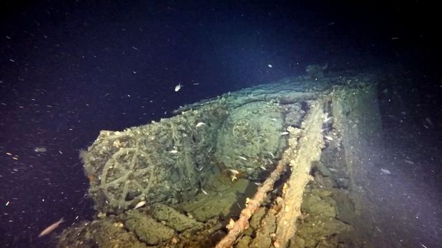 The torpedo loading hatch on the fore deck stands as a stark reminder of the vessel's combat readiness and strategic importance.