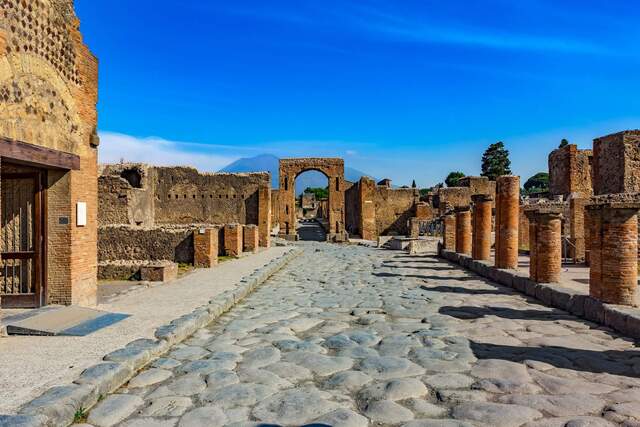 The well-preserved Roman road in Pompeii, showcasing the integration of pathways and curbs, designed for pedestrians and vehicles