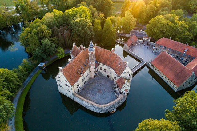 An aerial shot during sunset captures the castle’s beauty amidst its peaceful surroundings