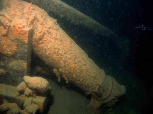 A pivot gun rests muzzle-down on the deck of the Hamilton, photographed in 1982. Though corroded on the surface, scientist Nancy Binnie of the Canadian Conservation Institute believes the iron beneath may still bear traces of its original foundry marks.