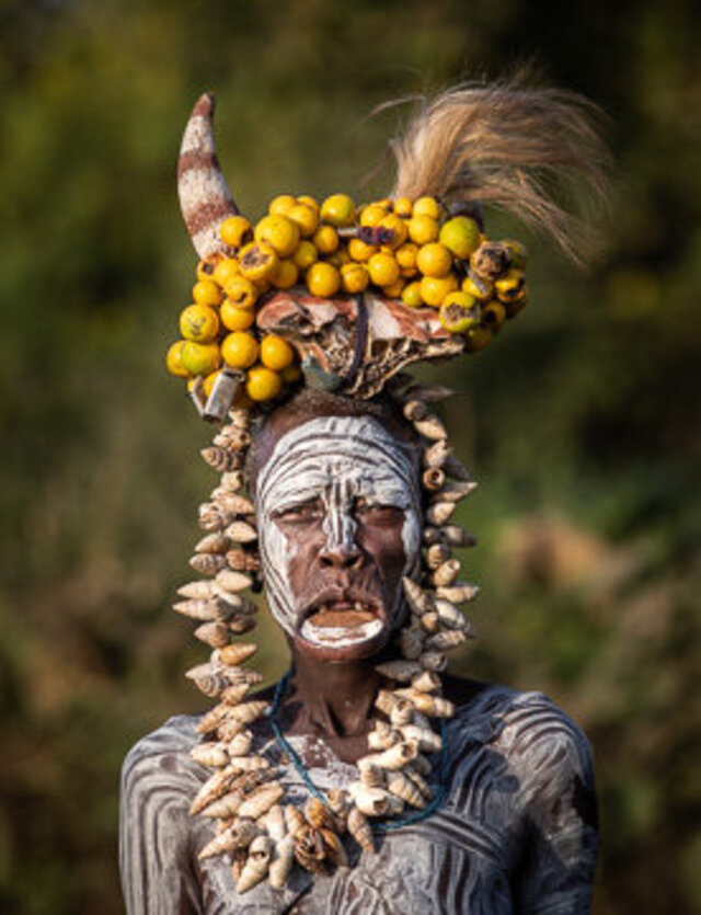 A Suri adorned with a traditional headdress made of shells and fruits, showcasing the beauty of cultural expressions. (Credit: Jayne Mclean) 