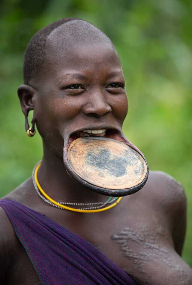 A Suri tribal woman from Ethiopia showcases the iconic lip plate tradition, a symbol of cultural identity among the Surma people. (Credit: Jayne Mclean) 